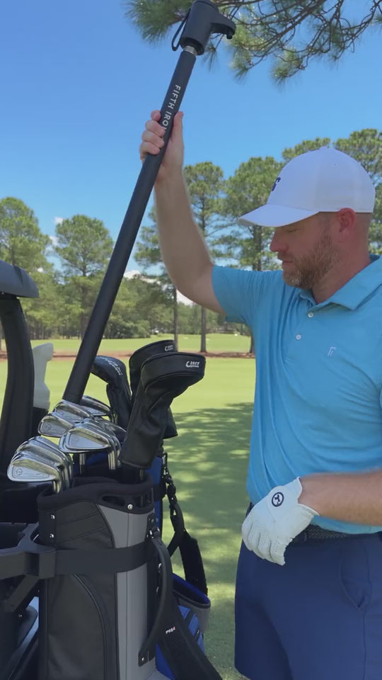 Golfer sliding a FIFTH IRON into a club slot