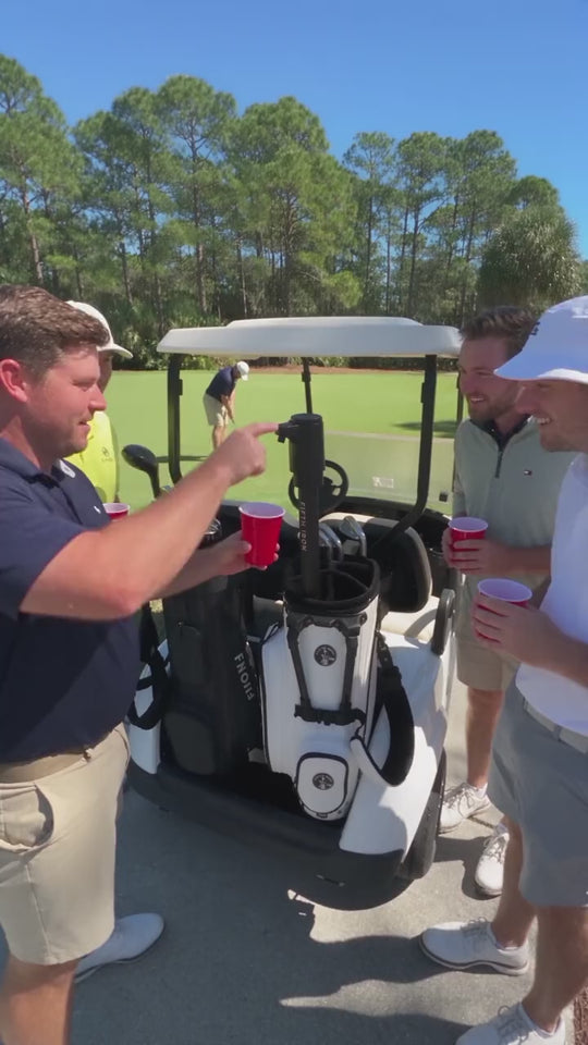 Foursome pouring drinks from a FIFTH IRON at the cart