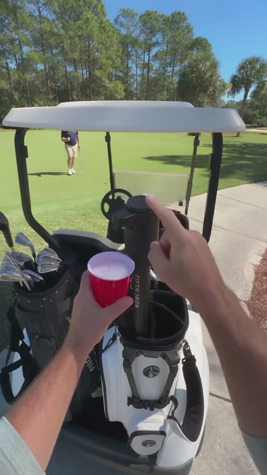 Two golfers fill cups from a FIFTH IRON and high-five